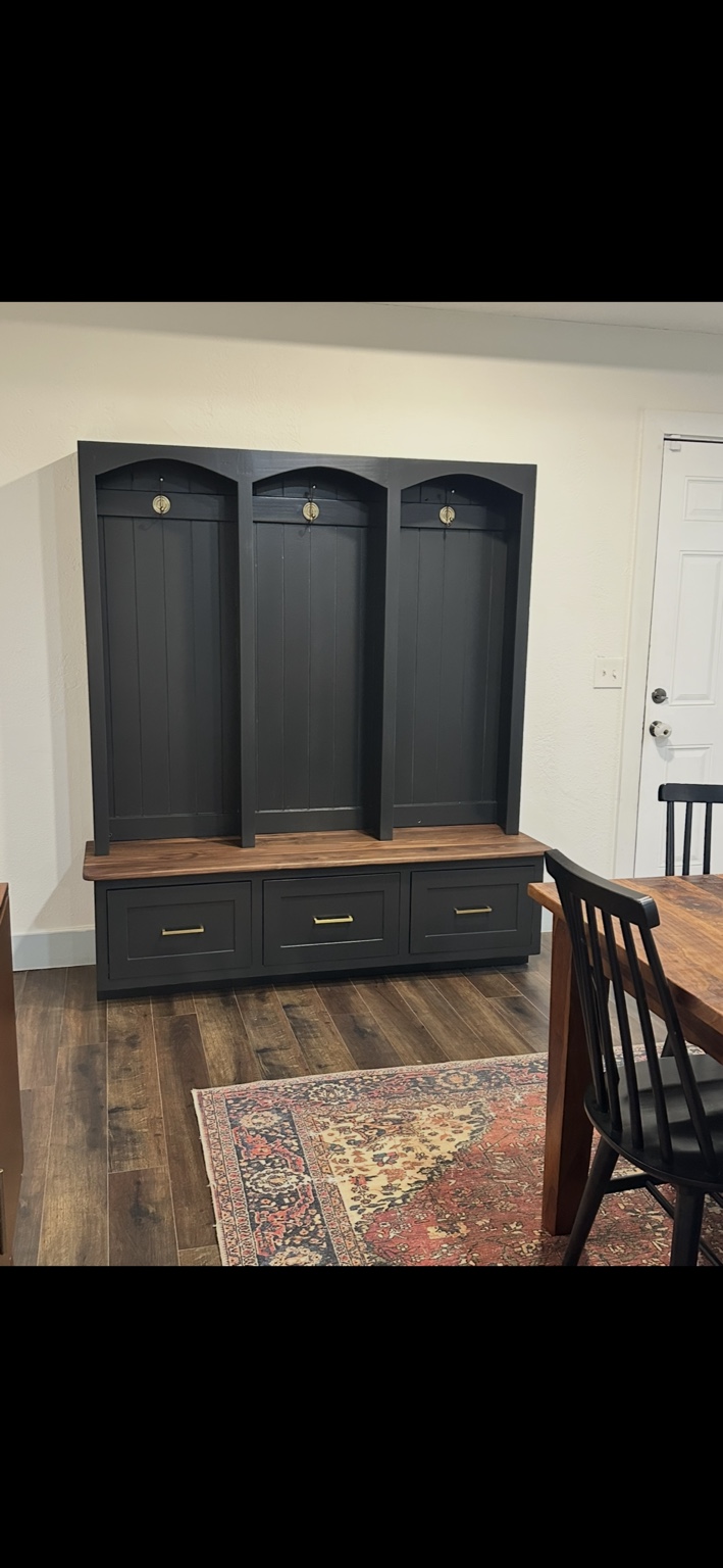 Hall tree with a wood bench seat and dark painted drawers